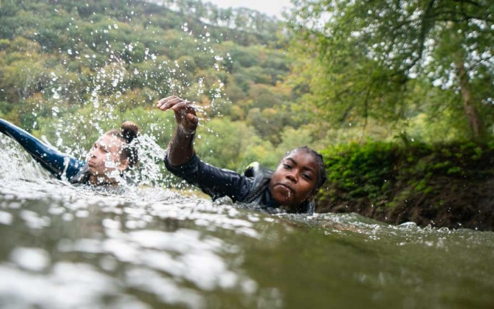 two students swim on an outward bound canoeing course